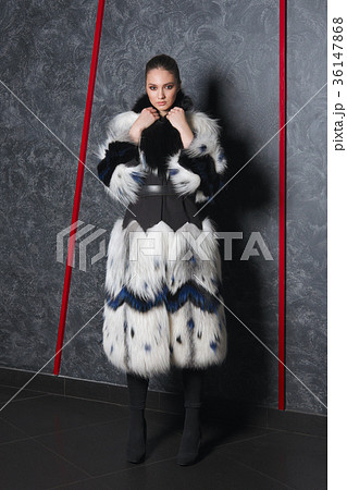 Attractive girl in long bouffant fur coat  36147868
