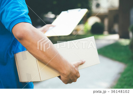 Delivery service courier in front of the house. 36148102