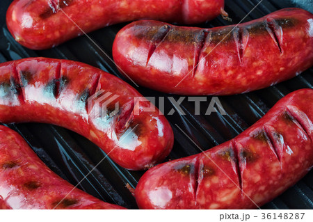 Fried sausages with golden crust on the grill Fried sausages with golden crust on the grill 36148287