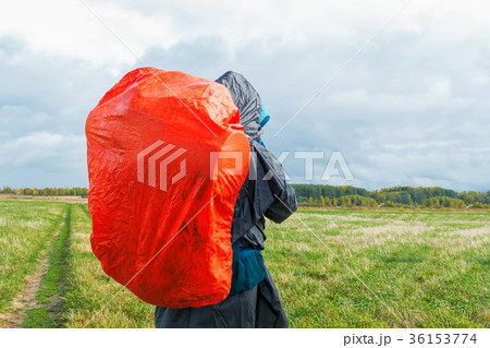 Backpacker on green field.Man hiking with backpack 36153774