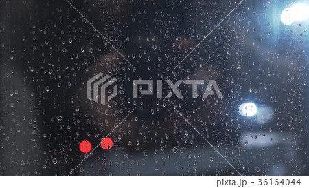 closeup of raindrops on window in night with 36164044