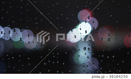 closeup of raindrops on window in night with 36164250