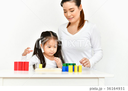 Parents are teaching children to do homework. 36164931