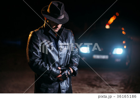 Maniac in black leather coat and hat, back view 36165186