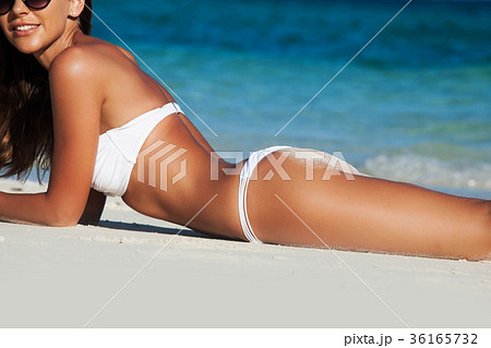 Woman laying by sea Woman laying by sea 36165732