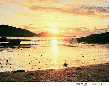 Walk within sunset on beach. Mirroring of sun Walk within sunset on beach. Mirroring of sun 36166173