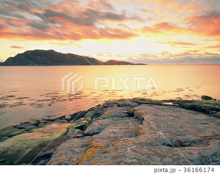 Mirroring of sunsetting horizon in sea water Mirroring of sunsetting horizon in sea water 36166174