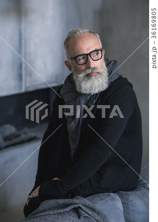 Pensive retire situating in living room 36169805