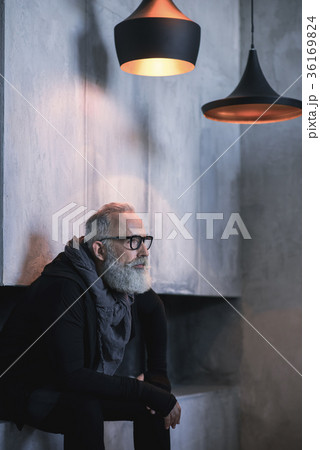 Serene mature male having rest in apartment 36169824
