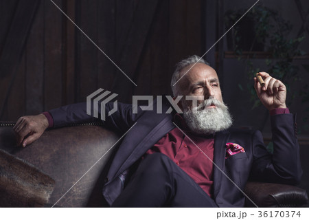 Serious bearded pensioner keeping tobacco 36170374