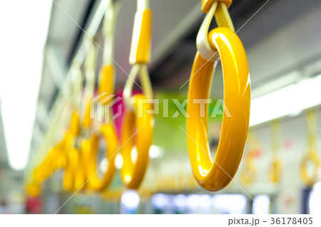 Yellow handrail holding bar inside of subway 36178405