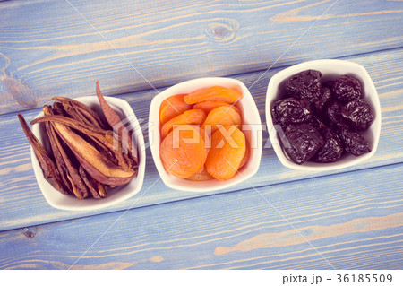 Dried fruits in white bowl on wooden boards 36185509