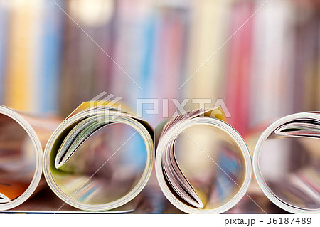 Close up edge of colorful magazine stacking roll Close up edge of colorful magazine stacking roll 36187489