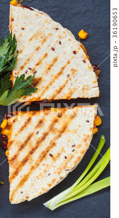 Pieces of quesadilla on slate, blue background Pieces of quesadilla on slate, blue background 36190653