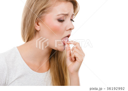 Woman having something disgusting on tongue 36192992