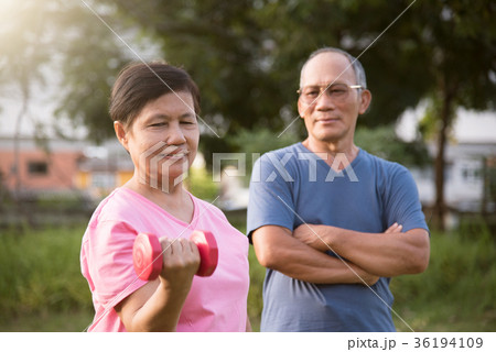 Asian Senior female lifting dumbbell. Asian Senior female lifting dumbbell. 36194109