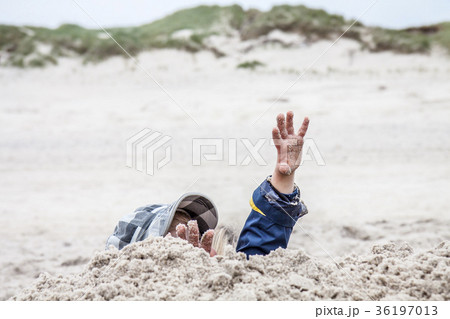 Young boy playing on the beach Young boy playing on the beach 36197013