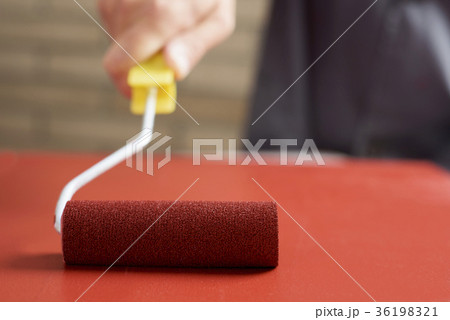 young man painting a wooden board young man painting a wooden board 36198321