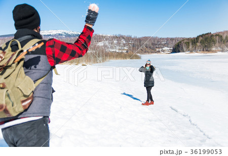 Couple snowball fighting and having fun Couple snowball fighting and having fun 36199053