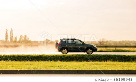 Suv car going fast on raining scenery. Suv car going fast on raining scenery. 36199943