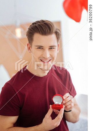 Excited gentleman smiling while holding proposal Excited gentleman smiling while holding proposal 36200799