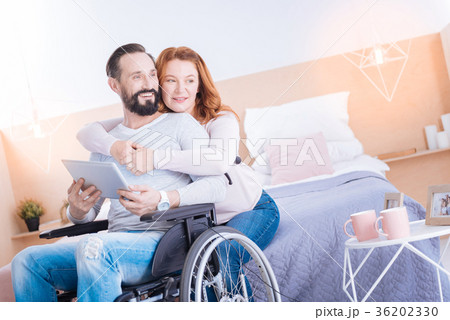 Smiling woman and disabled man relaxing together 36202330
