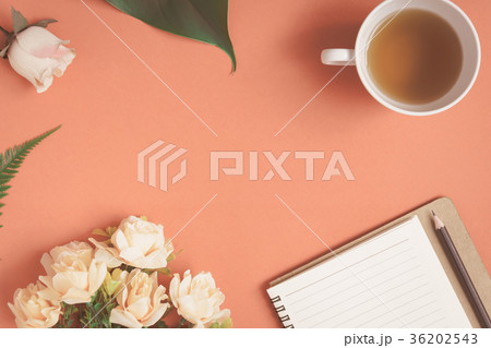 Flat lay Notebook and rose placed on a red desk Flat lay Notebook and rose placed on a red desk 36202543