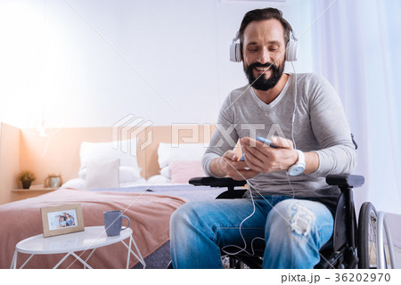 Smiling disabled man listening to music 36202970