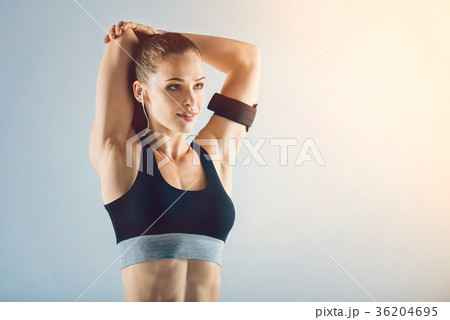 Beautiful young fitness lady stretching arms 36204695