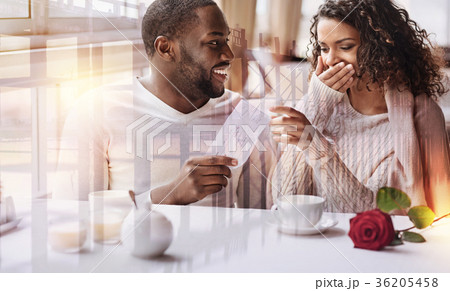 Close up of positive man showing flight tickets to Close up of positive man showing flight tickets to 36205458