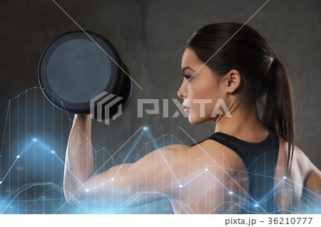 young woman flexing muscles with dumbbells in gym young woman flexing muscles with dumbbells in gym 36210777