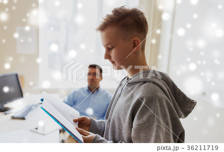 student boy with notebook and teacher at school 36211719