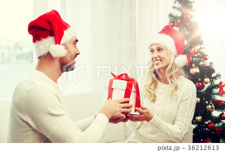 happy couple at home with christmas gift box 36212613