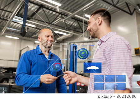 auto mechanic giving key to man at car shop auto mechanic giving key to man at car shop 36212686