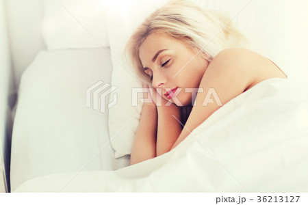 young woman sleeping in bed at home bedroom 36213127