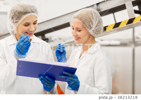 women technologists tasting ice cream at factory 36213219