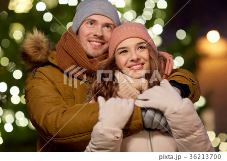 happy couple hugging at christmas tree happy couple hugging at christmas tree 36213700