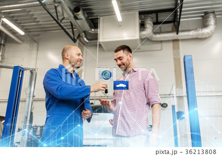 auto mechanic giving key to man at car shop auto mechanic giving key to man at car shop 36213808