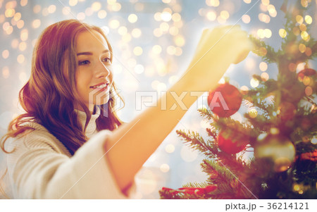 happy young woman decorating christmas tree 36214121
