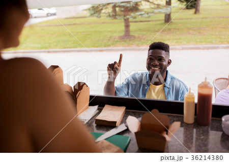 african american man ordering wok at food truck african american man ordering wok at food truck 36214380