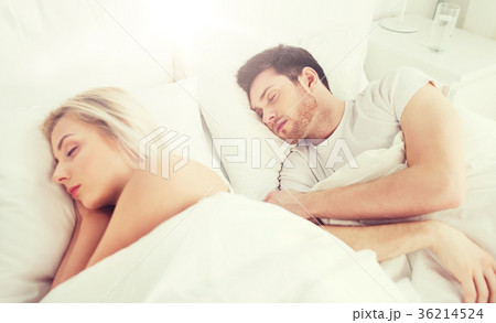 happy couple sleeping in bed at home happy couple sleeping in bed at home 36214524
