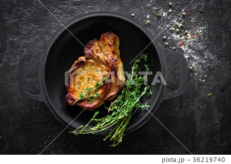 Pork meat, grilled steak on black background 36219740