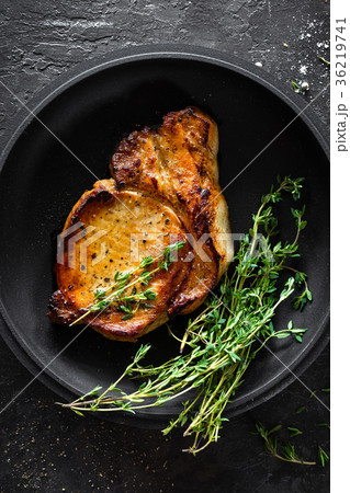 Pork meat, grilled steak on black background 36219741