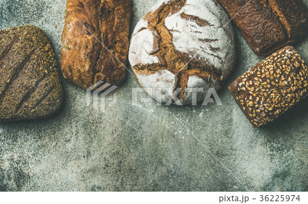 Top view of rustic bread loaves over grey Top view of rustic bread loaves over grey 36225974