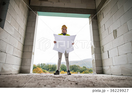 Young woman worker on the building site. Young woman worker on the building site. 36229927