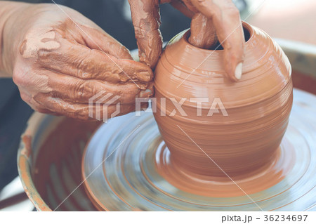 Potter making ceramic pot on the pottery wheel Potter making ceramic pot on the pottery wheel 36234697