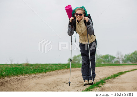 Positive hiker woman with a backpack Positive hiker woman with a backpack 36235881