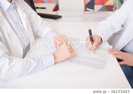 two doctors in gowns, sign documents two doctors in gowns, sign documents 36235883