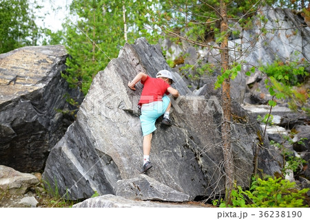 Young caucasian child boy climbing rocks in forest 36238190
