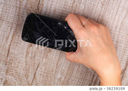 Smartphone with a broken screen in the girl's hand Smartphone with a broken screen in the girl's hand 36239109